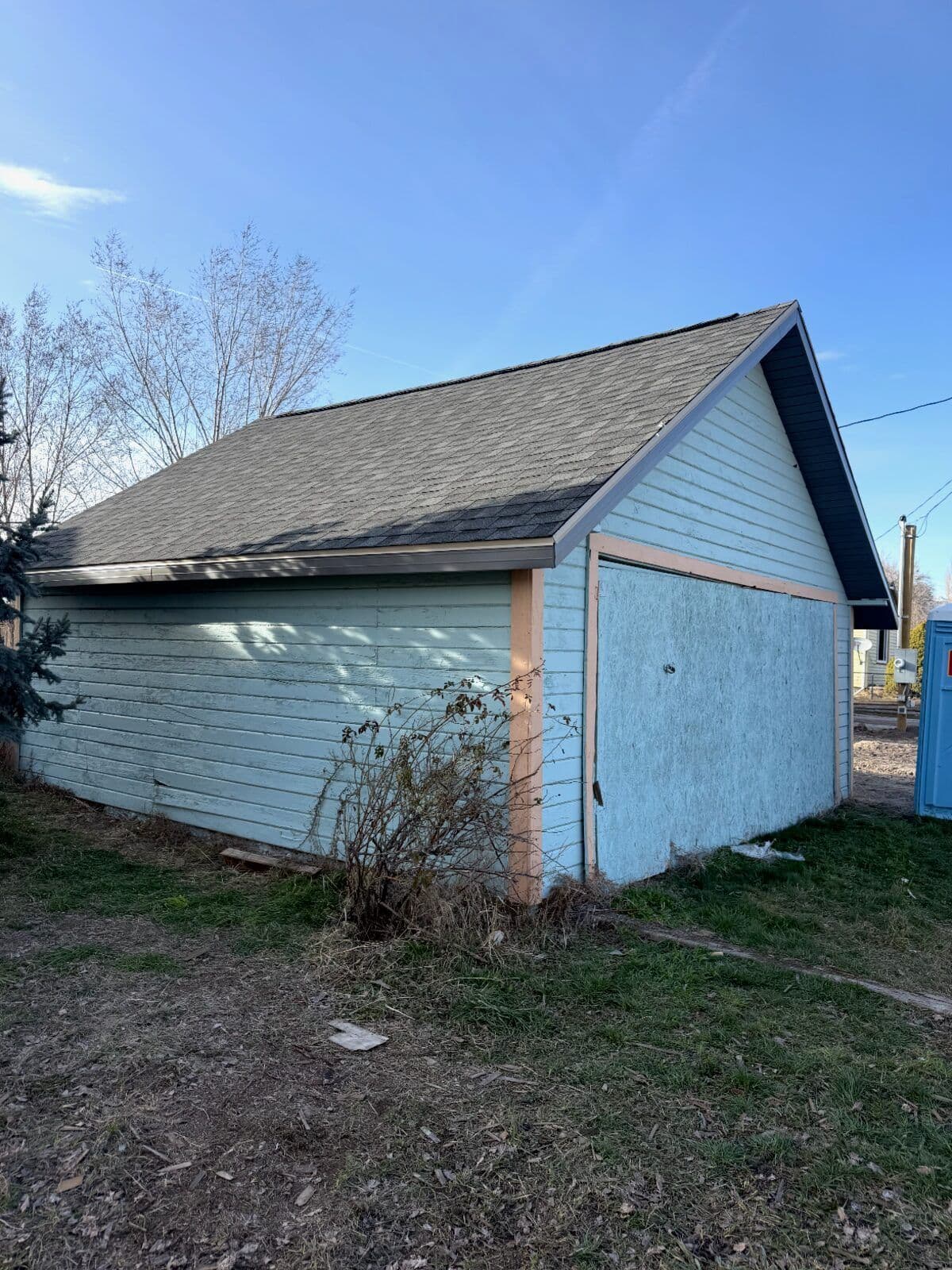 Building after new roof — clean dark asphalt shingles installed by White Pine