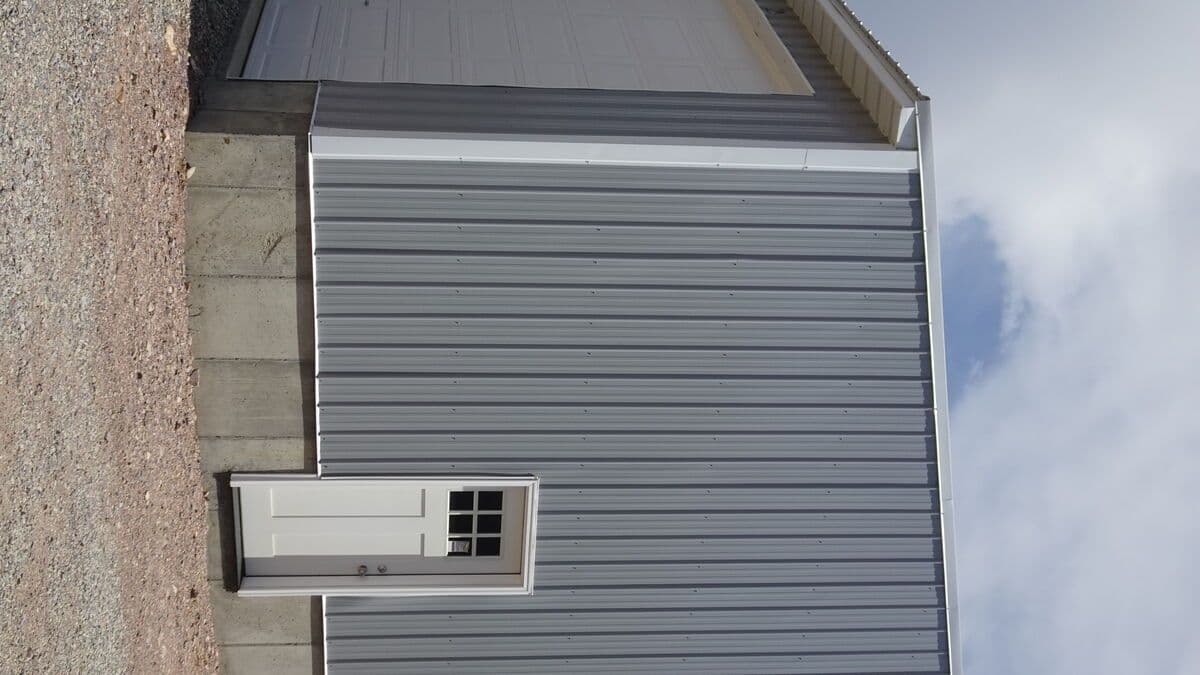 Close-up of storage building showing metal panel siding and roofing details
